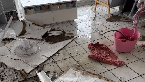 Janine Pirie ceiling on her living room floor after water began to pour in on Saturday as Ex-Tropical Cyclone Alfred crossed SEQ.