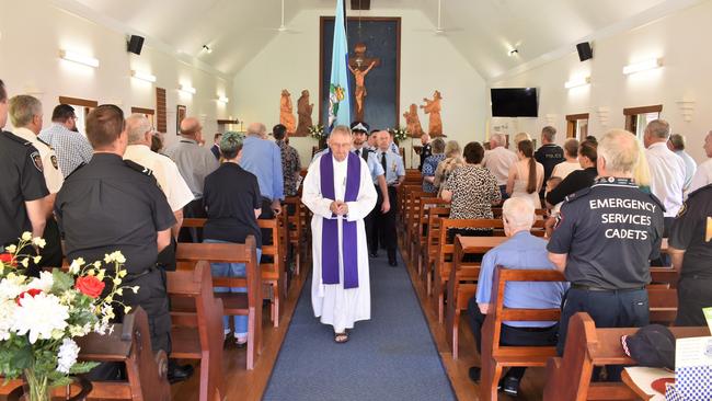 Father Paul Beasley, priest in charge of Hinchinbrook, and Constable Iain Russell lead the Queensland Police Service honour guard from church. Solemn National Police Remembrance Day at Holy Trinity Anglican Church Ingham on Thursday. Picture: Cameron Bates