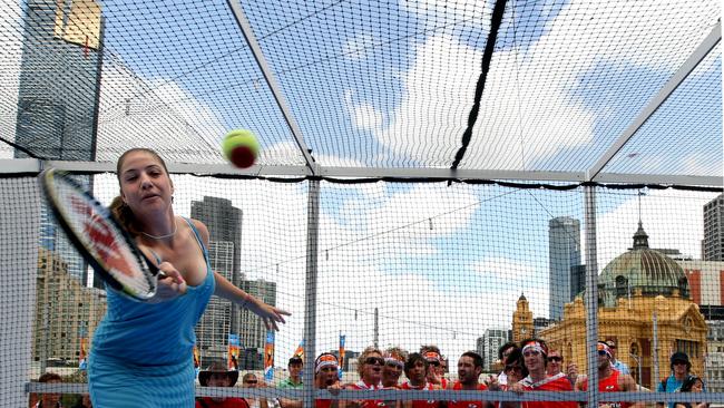 Russian Alisa Kleybanova hits with kids on a mini-tennis court set up at Federation Square during the 2020 Australian Open.