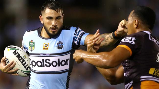 Shark's Jack Bird fends off the Bronco's Tautau Moga. Picture: Gregg Porteous