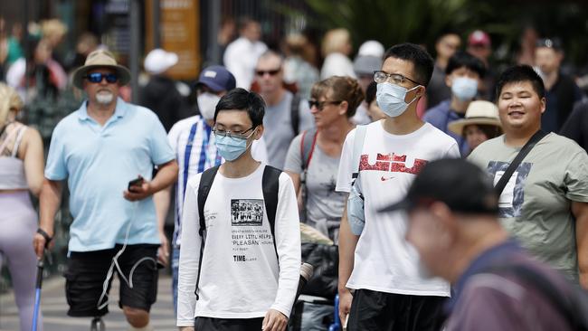 SYDNEY, AUSTRALIA - NewsWire photos NOVEMBER 21, 2022: People are seen wearing masks and choosing not to wear them at Circular Quay in Sydney. Picture: NCA NewsWire / Dylan Coker