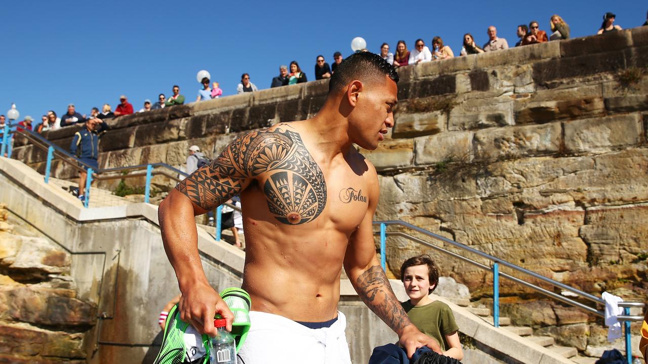 Israel Folau of the Wallabies is watched by a crowd at Coogee Beach.