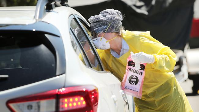 Pictured is a doctor conducting drive up COVID-19 tests. Picture: Richard Dobson