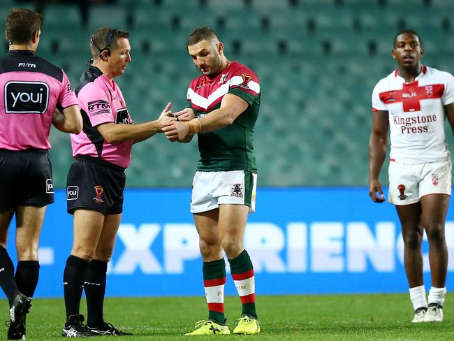 Robbie Farah of Lebanon makes an official complaint of biting against Jermaine McGillvary of England.