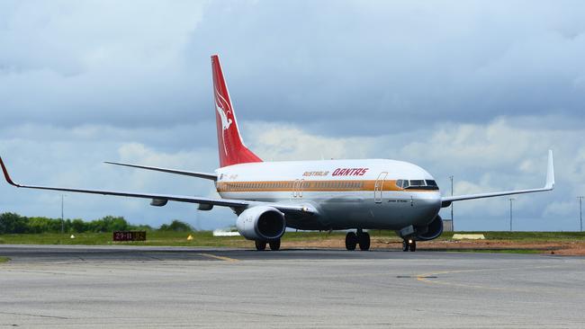 Qantas aircraft with retro paint job landing at Darwin International Airport.