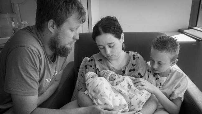 Cassandra with her husband Jake Oest and stepson with their twins Ellie and Aiden after they passed away. Picture: Supplied by family