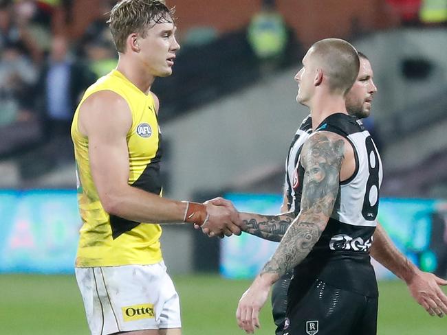 Tom Lynch of the Tigers and Hamish Hartlett of the Power shake hands.