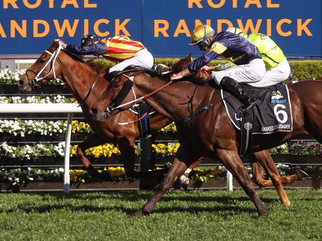 Nature Strip (L), ridden by jockey James McDonald, takes a lead to win the Everest 2021 horse race at the Royal Randwick race course in Sydney on October 16, 2021. (Photo by David Gray / AFP) / XGTY-- IMAGE RESTRICTED TO EDITORIAL USE - STRICTLY NO COMMERCIAL USE --