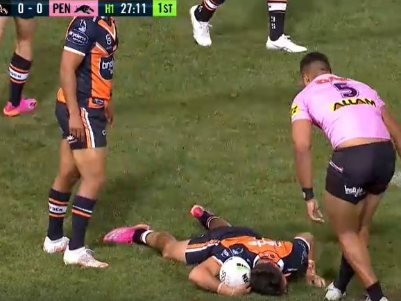 Wests Tigers fullback Daine Laurie stays down and attempts to ‘milk’ a penalty after copping a slap to the face against Penrith in round 13.