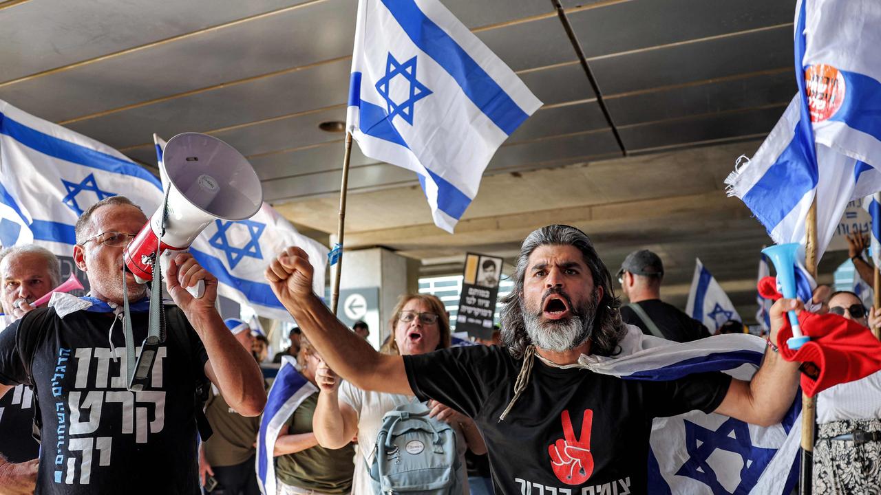 Anti-government protesters march at Israel's Ben Gurion Airport near Lod on July 3, 2023. (Photo by JACK GUEZ / AFP)