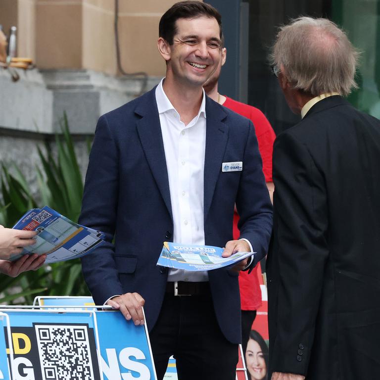 LNP Member for Brisbane Trevor Evans hands out how-to-vote cards at pre-polling at City Hall. Picture: Liam Kidston