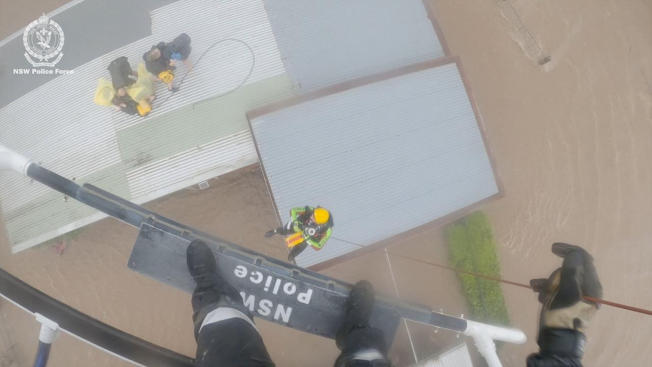 Ashley Cowan, 12, her brother Stanley, 14, their mum Anna and grandparents Richard and Rosanne, were safely rescued by winch and helicopter from their shed’s roof on 21 May 10.30am as floodwaters surrounded them. Picture: supplied/NSW Police Force