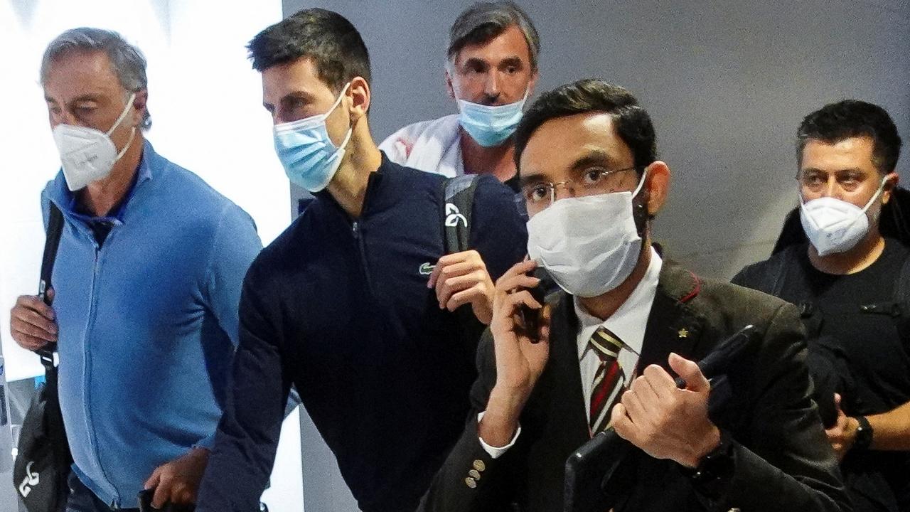 Serbian tennis player Novak Djokovic walks with his team after landing at Dubai Airport after the Australian Federal Court upheld a government decision to cancel his visa to play in the Australian Open, in Dubai, United Arab Emirates, January 17, 2022. REUTERS/Loren Elliott