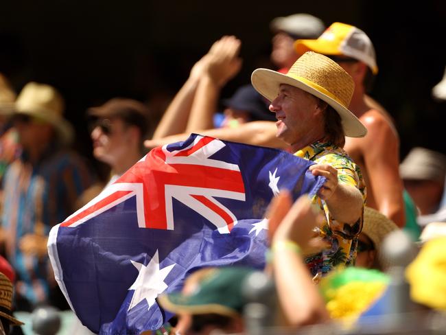 BRISBANE, AUSTRALIA - FEBRUARY 14: A supporter in the crowd waves and Australia flag during the Fourth One Day International match between Australia and the West Indies at The Gabba on February 14, 2010 in Brisbane, Australia. (Photo by Mark Kolbe/Getty Images)