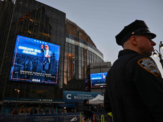 A New York Police Department officer provides security as supporters of former US President and Republican presidential candidate Donald Trump arrive for a campaign rally at Madison Square Garden in New York. Picture: AFP