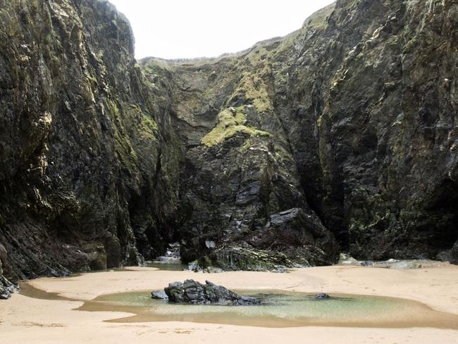 ONE TIME WEB USE ONLY - FEE APPLIES FOR REUSE -  The Crantock rock carving on Crantock Beach, Devon that reveal a beautiful secret at low tide.See SWNS story SWCAVE; Images reveal a hidden poem carved inside a Cornish cave which is only accessible at low tide. Crantock might only be a stone's throw from Newquay, Cornwall's liveliest resort, but its location between the two Pentire headlands ensures it remains a place of peace and tranquility. On the far side of the beach, an intriguing series of small caves hidden in the cliff walls hold a secret few could ever spot without knowing what to look for. Only at low tide can you see the mythical Crantock rock carving, which is the stuff of legend in the local area.  Picture: SWNS/Mega