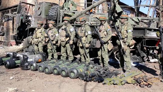 Russian soldiers display what it claimed were captured Western-made portable missile systems from Ukrainian service members in the Kyiv region. Picture: Reuters