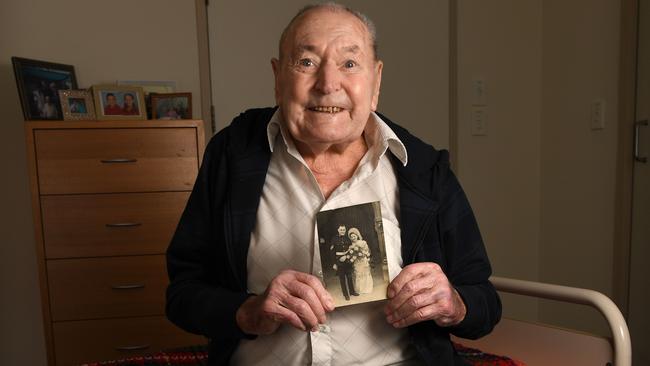 Charles Oram, now 95, holding a photo of his wedding day to Sylvia in June 1945. Picture: Tricia Watkinson