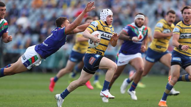 Reed Mahoney makes a break against the Warriors at Central Coast Stadium yesterday. The Eels hooker will miss the clash with Penrith after injuring his shoulder. Picture: Brett Costello