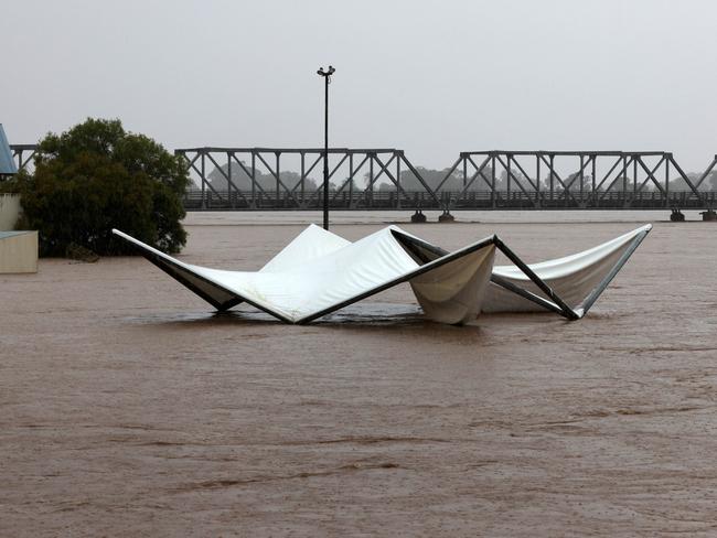 Floodwaters are seen in and around Taree on the mid-north coast of NSW as torrential rain inundates the region, cutting off communities with NSW SES crews winching people to safety from rooftops and surging rivers. Picture: NewsWire / Scott Calvin