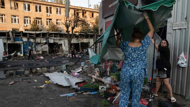 EDITORS NOTE: Graphic content / Women work at the site of a Russian strike at a market in Kostyantynivka, Ukraine's eastern Donetsk region on September 6, 2023, amid the Russian invasion of Ukraine. A Russian strike killed at least 17 people at a market in east Ukraine, officials said, in an attack that President Volodymyr Zelensky described as deliberate and 