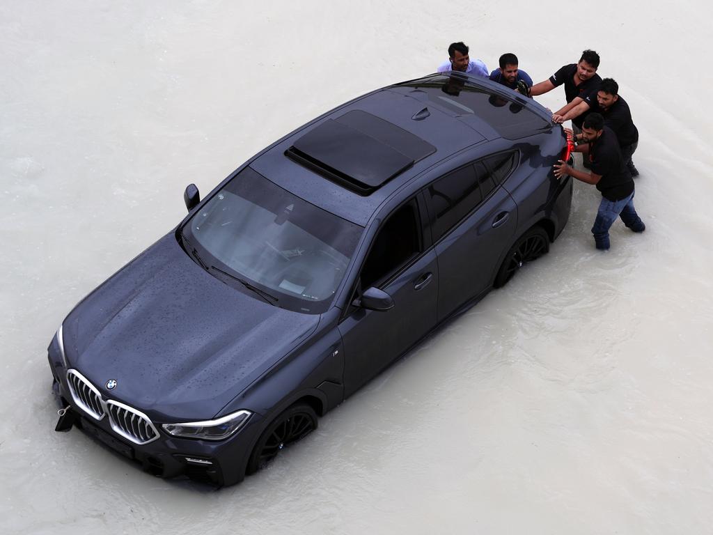 Photos show luxury cars submerged in deep water. Picture: Ali Haider/EPA/AAP