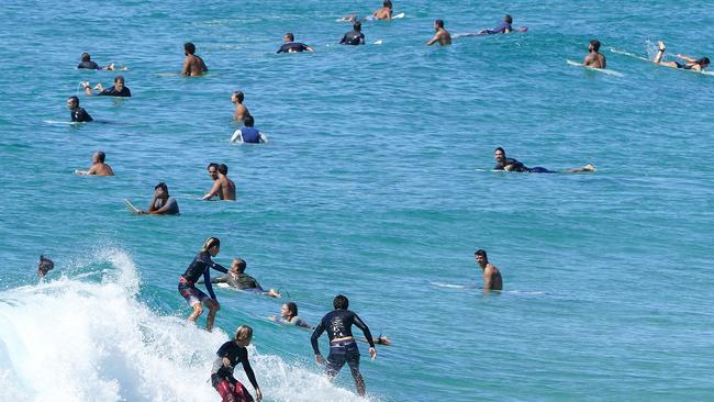 Surfers in the water at Duranbah on the Queensland - New South Wales border this morning. Picture: Dave Hunt/AAP