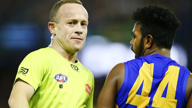 Umpire Ray Chamberlain isn’t sure what to make of Willie Rioli’s love tap.