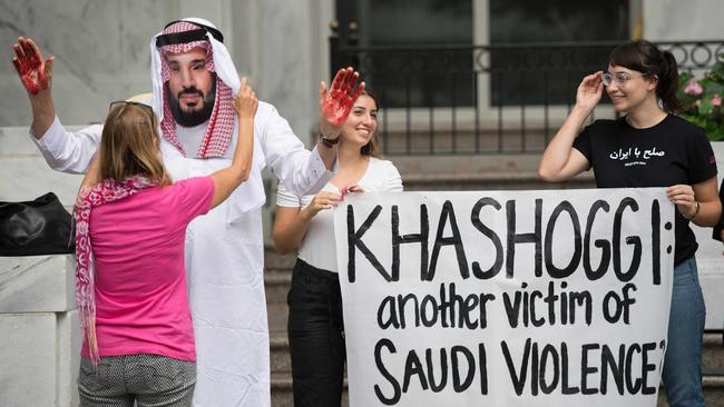 A demonstrator dressed as Saudi Arabian Crown Prince Mohammed bin Salman with blood on his hands protests with others outside the Saudi Embassy in Washington, DC.