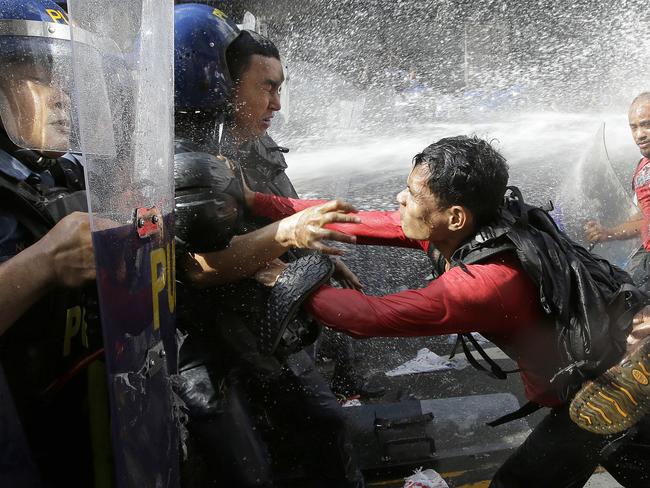 A protester pushes a police as they are dispersed while trying to get near the U.S. Embassy in Manila. Picture: AP