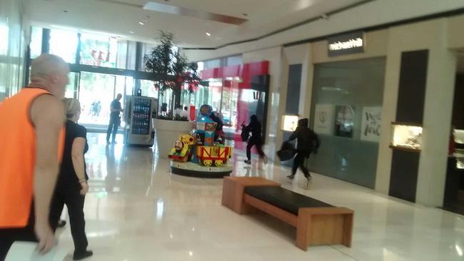 David took this photo seconds after the brazen burglary. Two men in black carrying bags can be seen dashing for the exit.