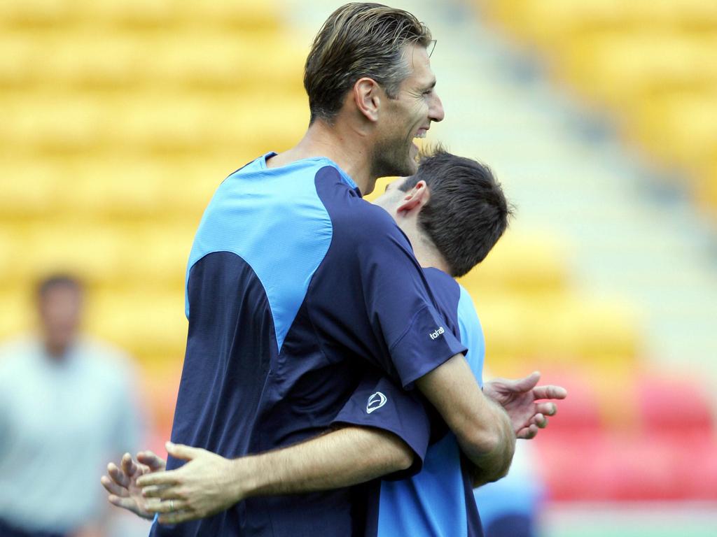 Zeljko Kalac engulfs Ante Milicic in a hug at Socceroos training in 2004.