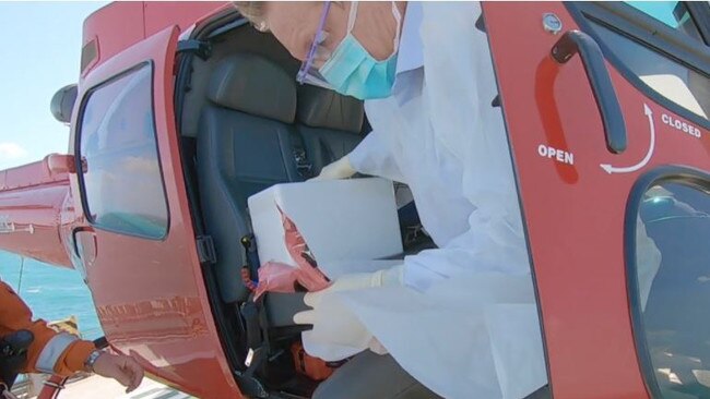 Dr John McIntosh getting off the helicopter during 30 knot winds. Picture: supplied