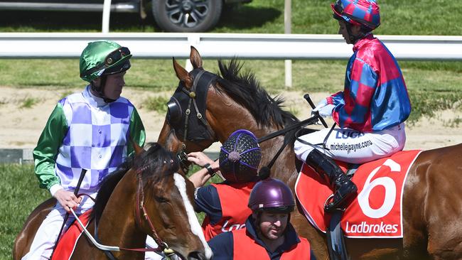 Prince Of Penzance and jockey John Allen pass Michelle Payne (rear) riding Dandy Gent before the start of the Herbert Power Stakes. Picture: Getty Images