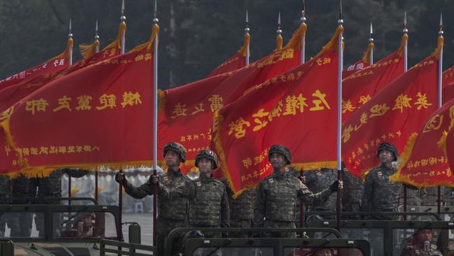 Chinese soldiers ride in jeeps as they drive in a parade to celebrate the 70th Anniversary of the founding of the People's Republic of China in 1949, at Tiananmen Square on October 1, 2019 in Beijing.