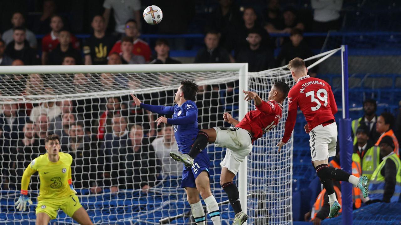 Manchester United's Brazilian midfielder Casemiro (2nd R) jumped into the crowd of players to head home their late equalizer during the English Premier League soccer match between Chelsea and Manchester United at Stamford Bridge in London on Jan. October 22, 2022. (Photo by ADRIAN DENNIS/AFP)