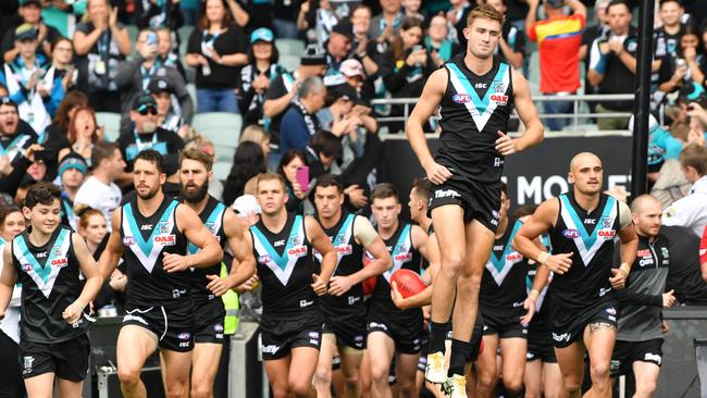 Power players run onto Adelaide Oval before taking on Gold Coast. Picture: AAP Image/David Mariuz