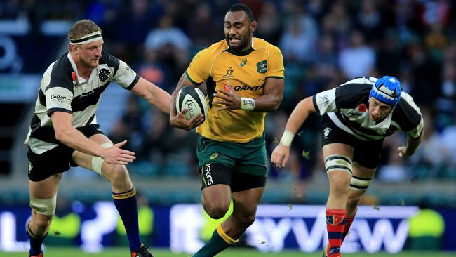 LONDON, ENGLAND - NOVEMBER 01: Tevita Kuridrani of Australia bursts past Dominic Bird (l) and Matias Alemanno (r) of the Barbarians during The Killik Cup match between the Barbarians and The Australian Wallabies at Twickenham Stadium on November 1, 2014 in London, England. (Photo by David Cannon/Getty Images)