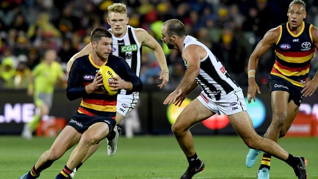 Bryce Gibbs tries to evade Steele Sidebottom on Friday night. Picture: AAP Image/Sam Wundke