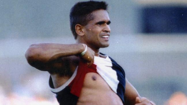 Footballer Nicky Winmar lifts his guernsey and pointing to his skin says "I'm black and I'm proud" to jeering Collingwood fans on April 26, 1993.