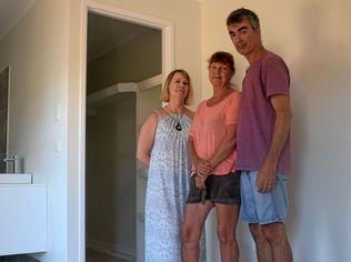 Lynette Arnall, Janine Lockhart and Tom DeFlorencas in the duplex which was left incomplete when Stirling Homes went bust. Picture: Scott Kovacevic