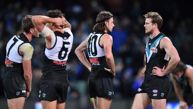 Dejected Port players after Jeremy McGovern kicked a goal after the siren at Adelaide Oval on Saturday. Picture: AAP Image/David Mariuz