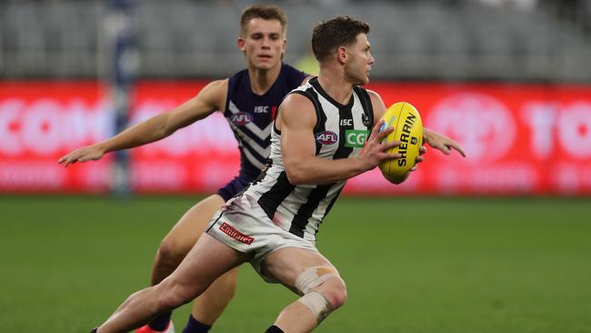 Young Docker Caleb Serong closes in on Collingwood’s Taylor Adams on Sunday. Picture: Getty Images