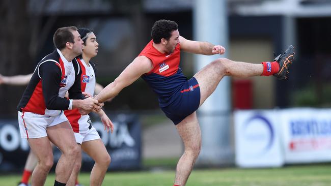 Michael Rogers gets in a clearing kick for Bentleigh.