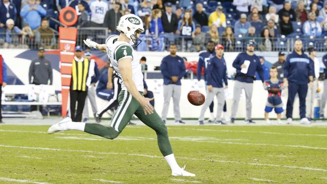 Lachie Edwards punts against the Tennessee Titans.