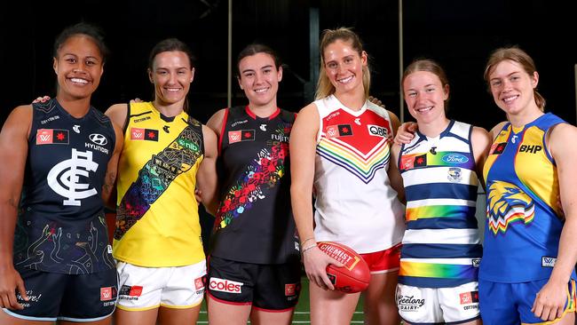 MELBOURNE, AUSTRALIA - OCTOBER 13: (L-R) Mua Laloifi of the Blues, Eilish Sheerin of Tigers, Bonnie Toogood of the Bombers, Alice Mitchell of the Swans, Mikayla Bowen of the Cats, and Bella Lewis of the Eagles pose for a portrait during the 2022 AFLW Pride Round Launch at Ikon Park on October 13, 2022 in Melbourne, Australia. (Photo by Kelly Defina/Getty Images)