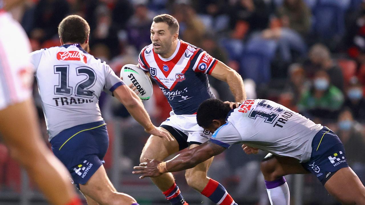 NEWCASTLE, AUSTRALIA – JULY 01: James Tedesco of the Roosters is tackled during the round 16 NRL match between the Sydney Roosters and the Melbourne Storm at McDonald Jones Stadium, on July 01, 2021, in Newcastle, Australia. (Photo by Ashley Feder/Getty Images)