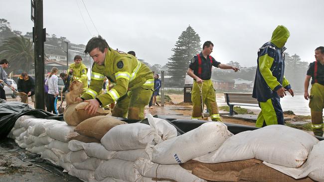 Surf club members, locals &amp; fire fighters laid sandbags to protect the Avoca Beach Surf Club &amp; cafe, as the storm swell threatened to flood them. Picture: Troy Snook