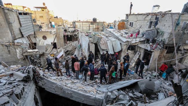 People inspect the damage to their homes following Israeli air strike in Rafah, Gaza. Picture: Ahmad Hasaballah/Getty Images