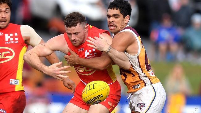 Pearce Hanley is tackled by Charlie Cameron.